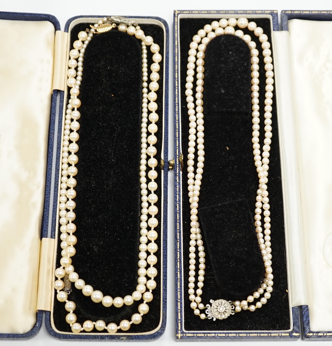 Three assorted cultured pearl necklaces, including two single strand and a double strand with diamond chip set 9ct white gold clasp, 44cm.